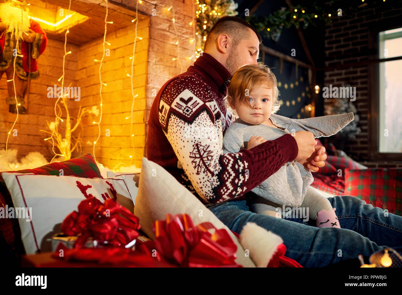 Father with a baby in a Christmas room. Stock Photo