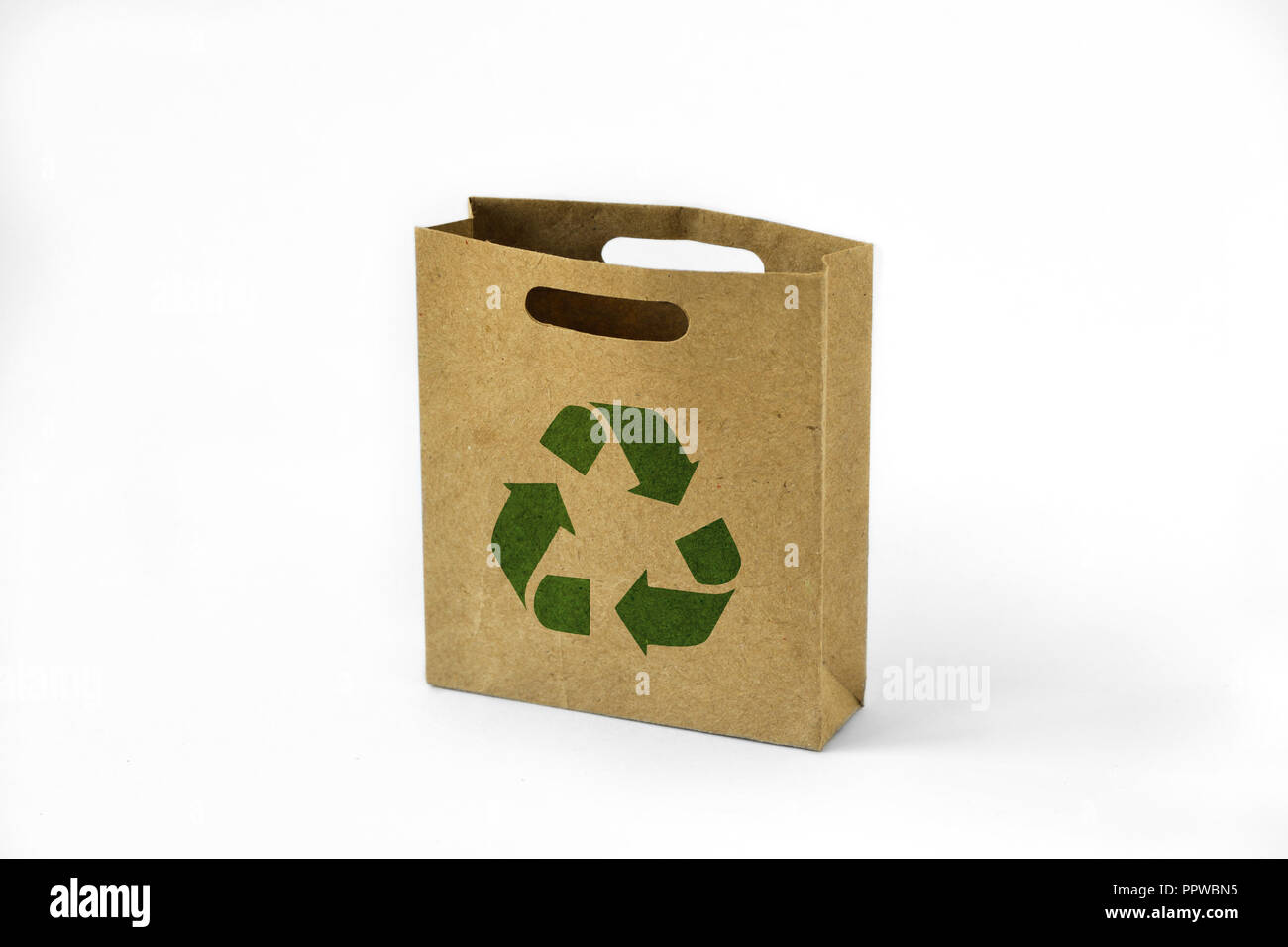 Paper shopping eco bag with green recycle symbol on white background Stock Photo
