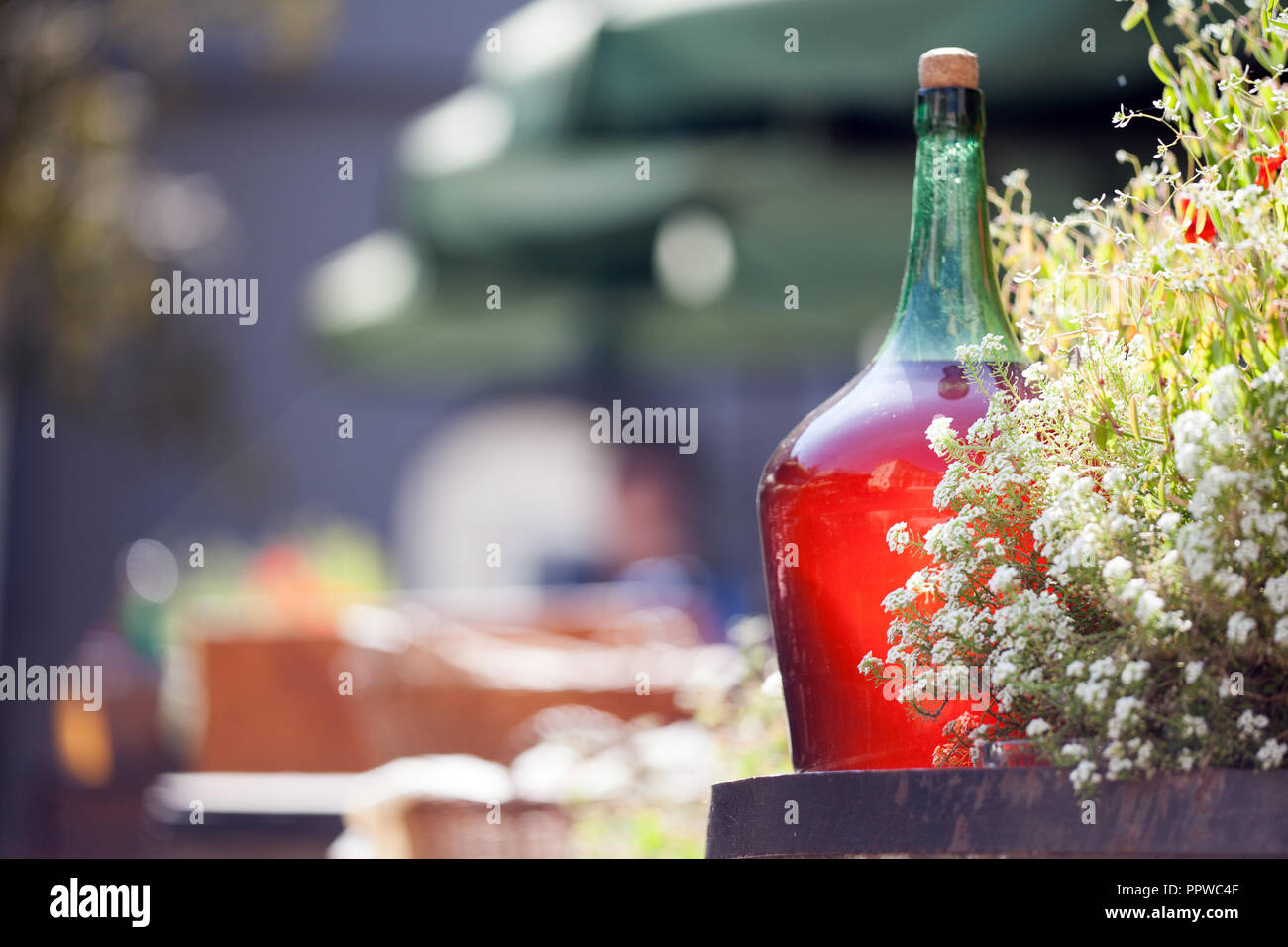 Large Vintage Wine Bottles of red wine standing on a barrel. Old sealed