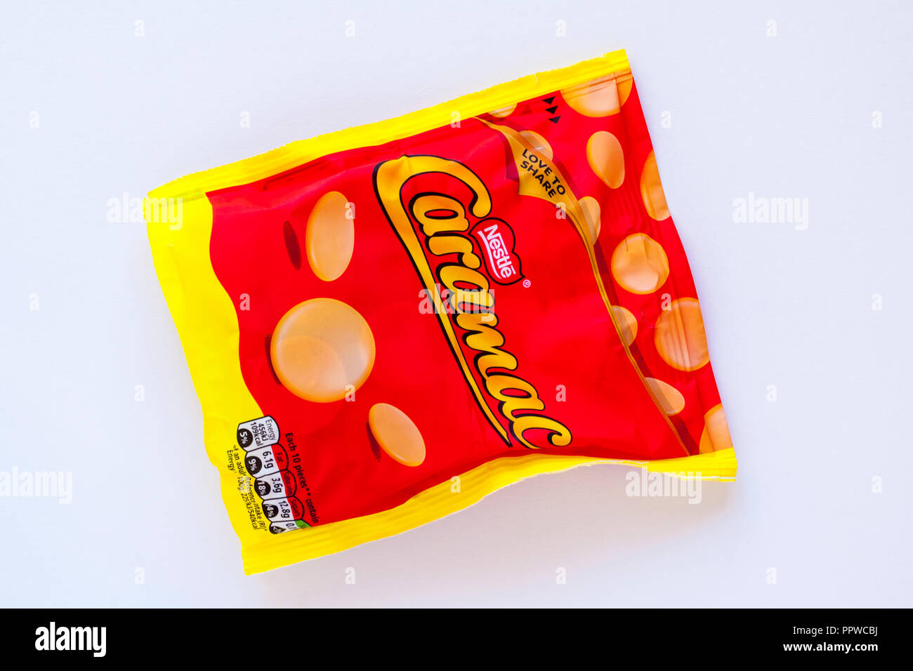 Bag of Nestle Caramac isolated on white background - caramel flavour pieces Stock Photo