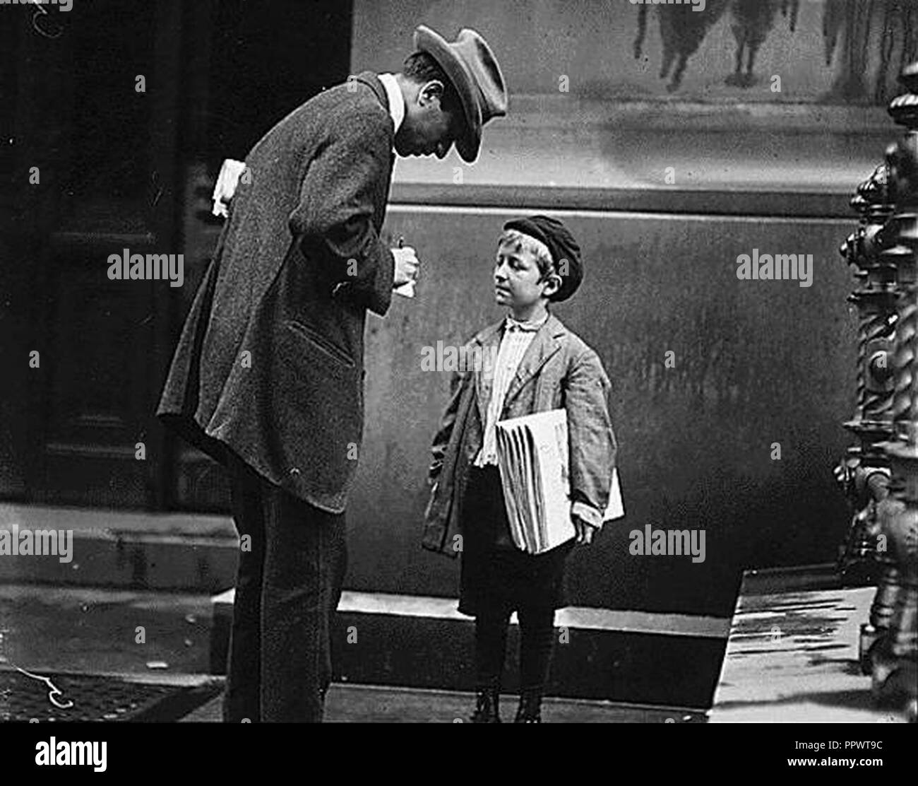 Boy selling newspapers by Lewis Hine. Stock Photo
