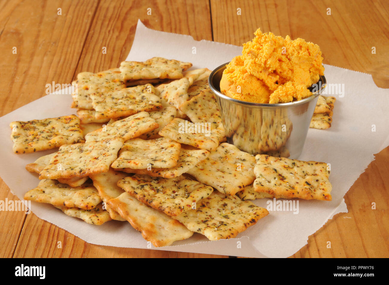 Crispy herb flatbread crackers with cheddar bacon cheese dip Stock Photo Alamy