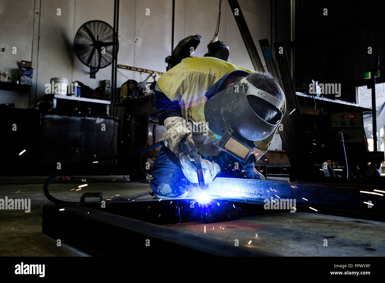 Man welding in workshop on mine site. Stock Photo