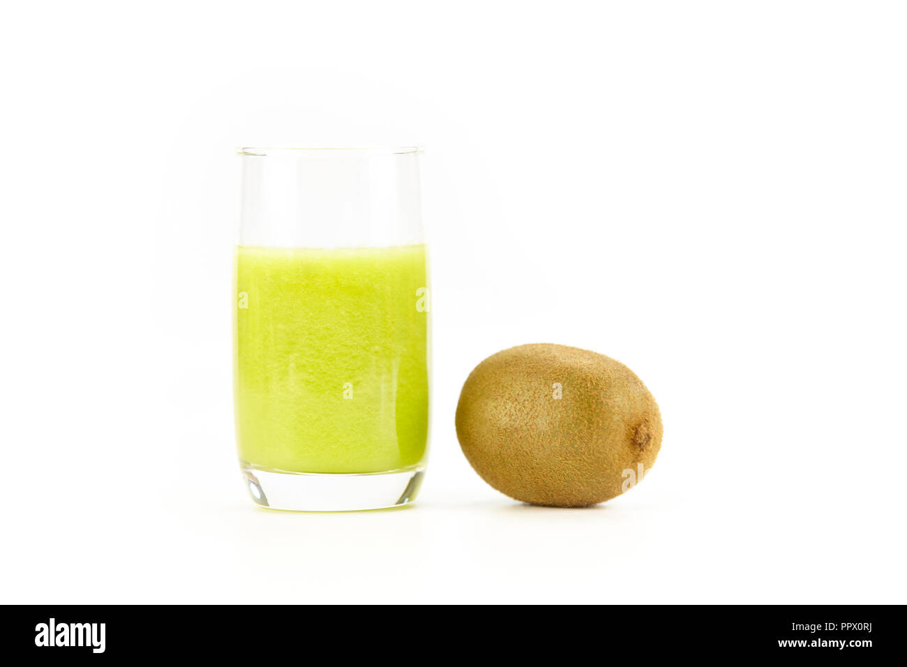 one kiwi fruit and a glass of kiwi juice isolated on white background. Stock Photo