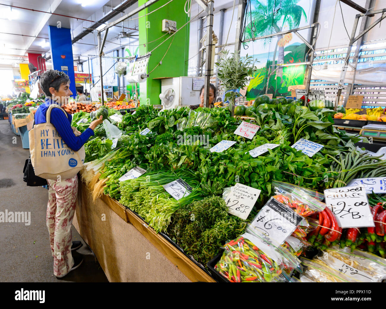 Customer buying fresh produce at the popular Rusty's Market on Sheridan
