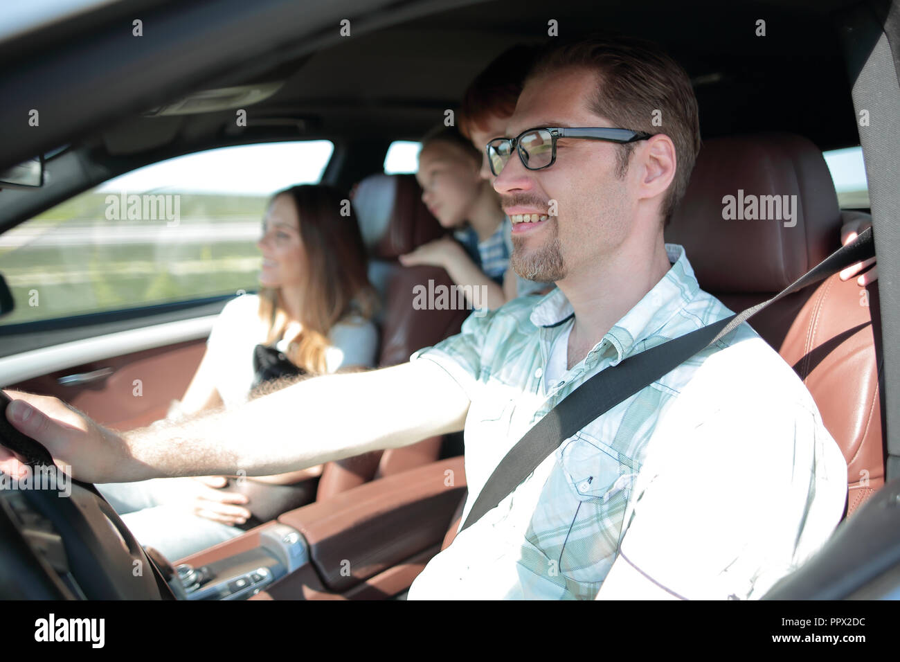 side view.happy father driving a car Stock Photo - Alamy
