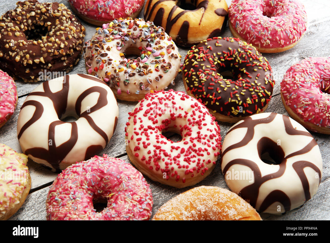 assorted donuts with chocolate frosted, pink glazed and sprinkles ...
