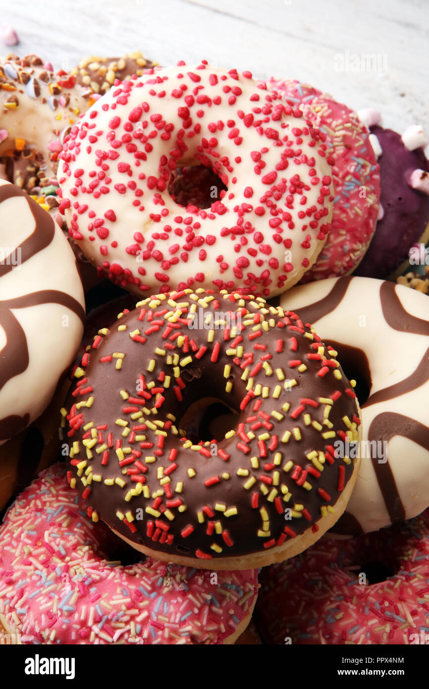 assorted donuts with chocolate frosted, pink glazed and sprinkles ...