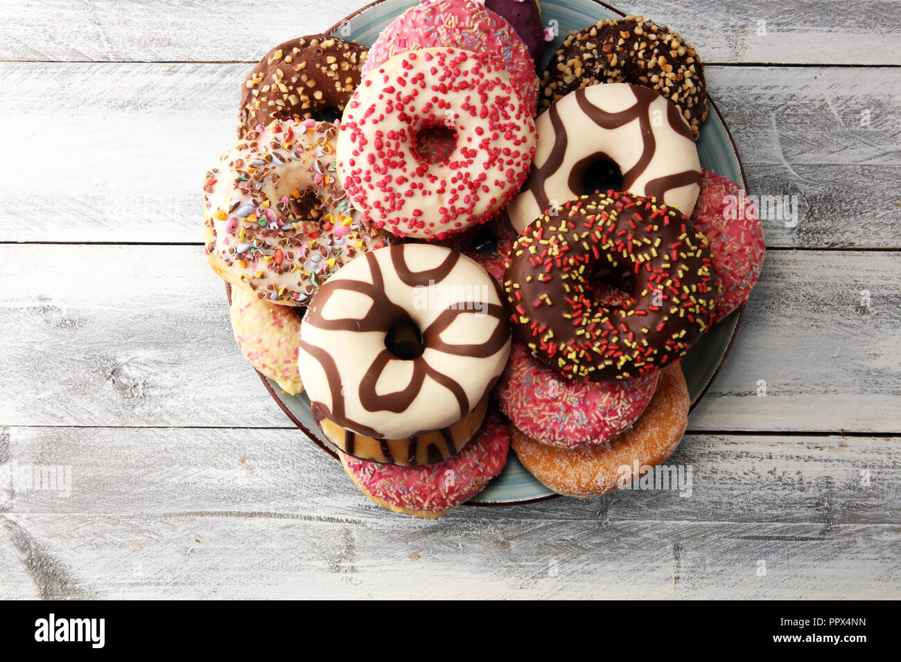 assorted donuts with chocolate frosted, pink glazed and sprinkles ...