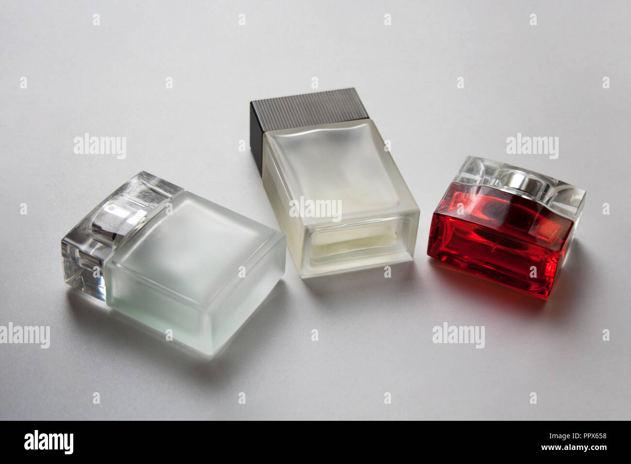 Three rectangular glass perfume bottles isolated on white background Stock Photo