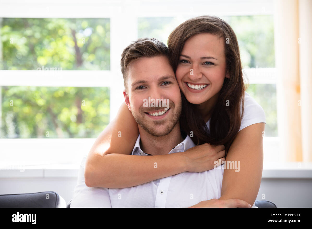 Portrait Of A Happy Young Couple At Home Stock Photo - Alamy