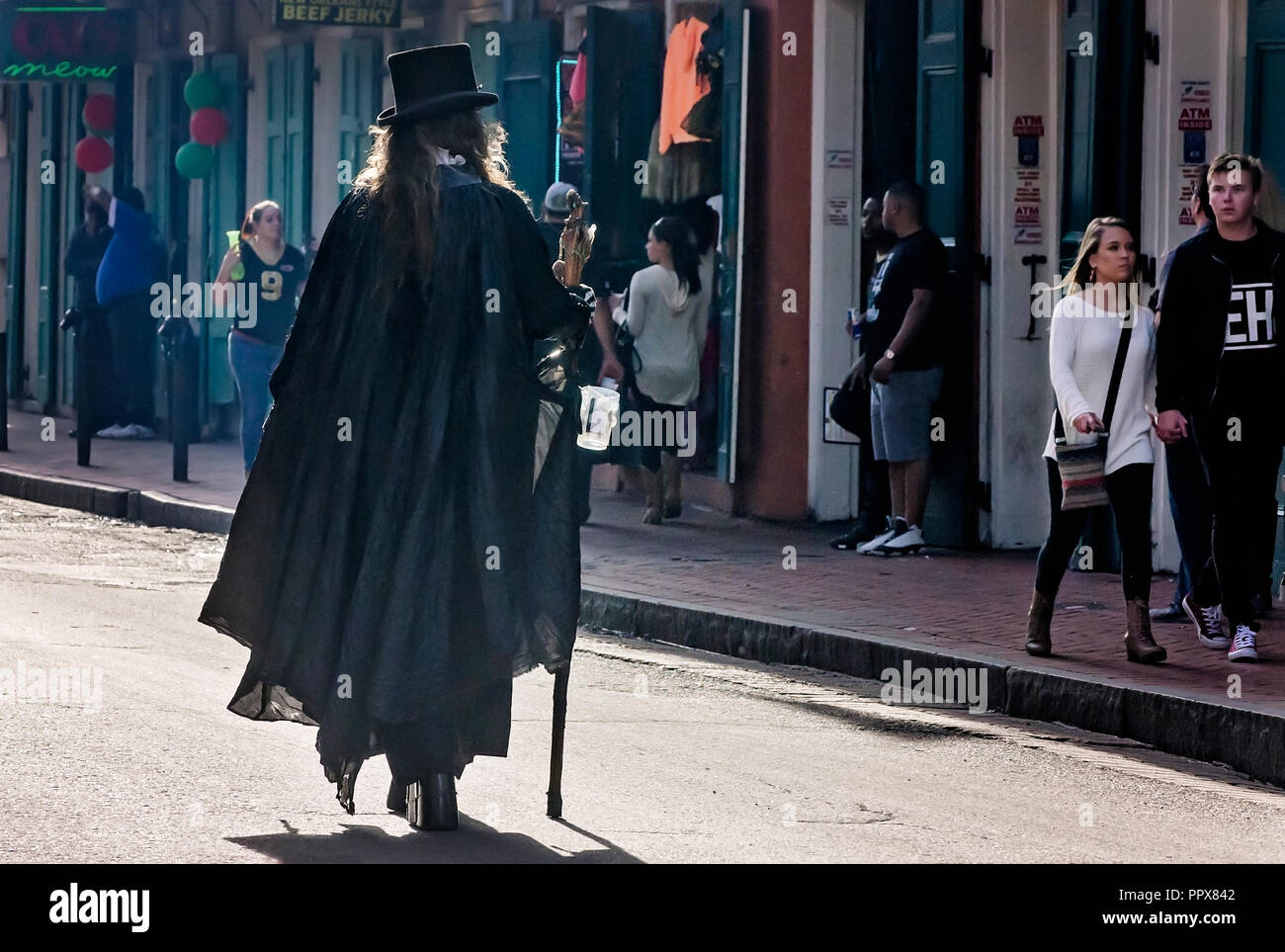 A street performer wearing a black cloak walks through the French Quarter collecting money, Nov. 15, 2015, in New Orleans, Louisiana. (Photo by Carmen Stock Photo