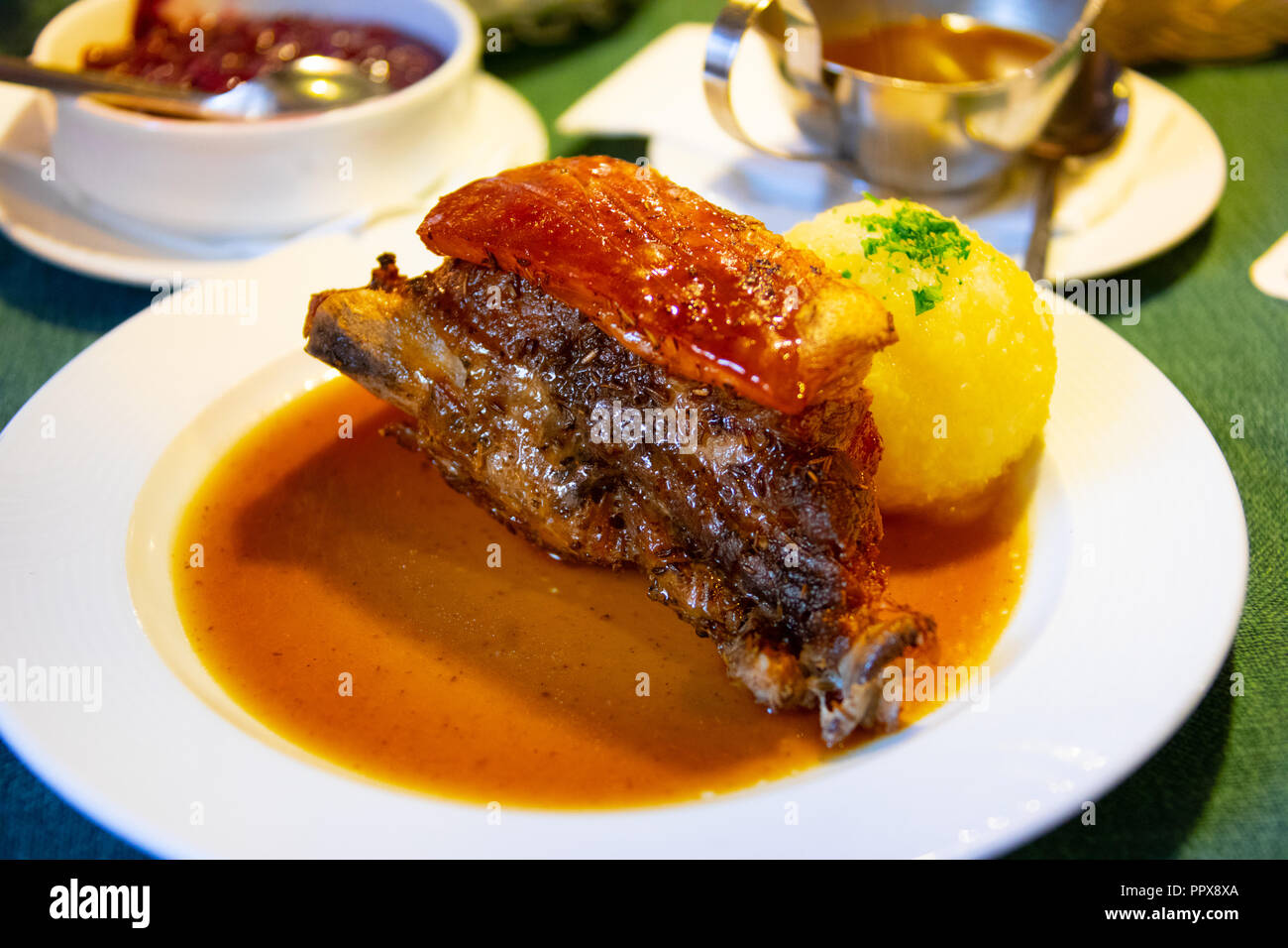 Pork shoulder with crackling skin at Albrecht Durer Stube, a traditional restaurant in Nuremburg, Germany Stock Photo