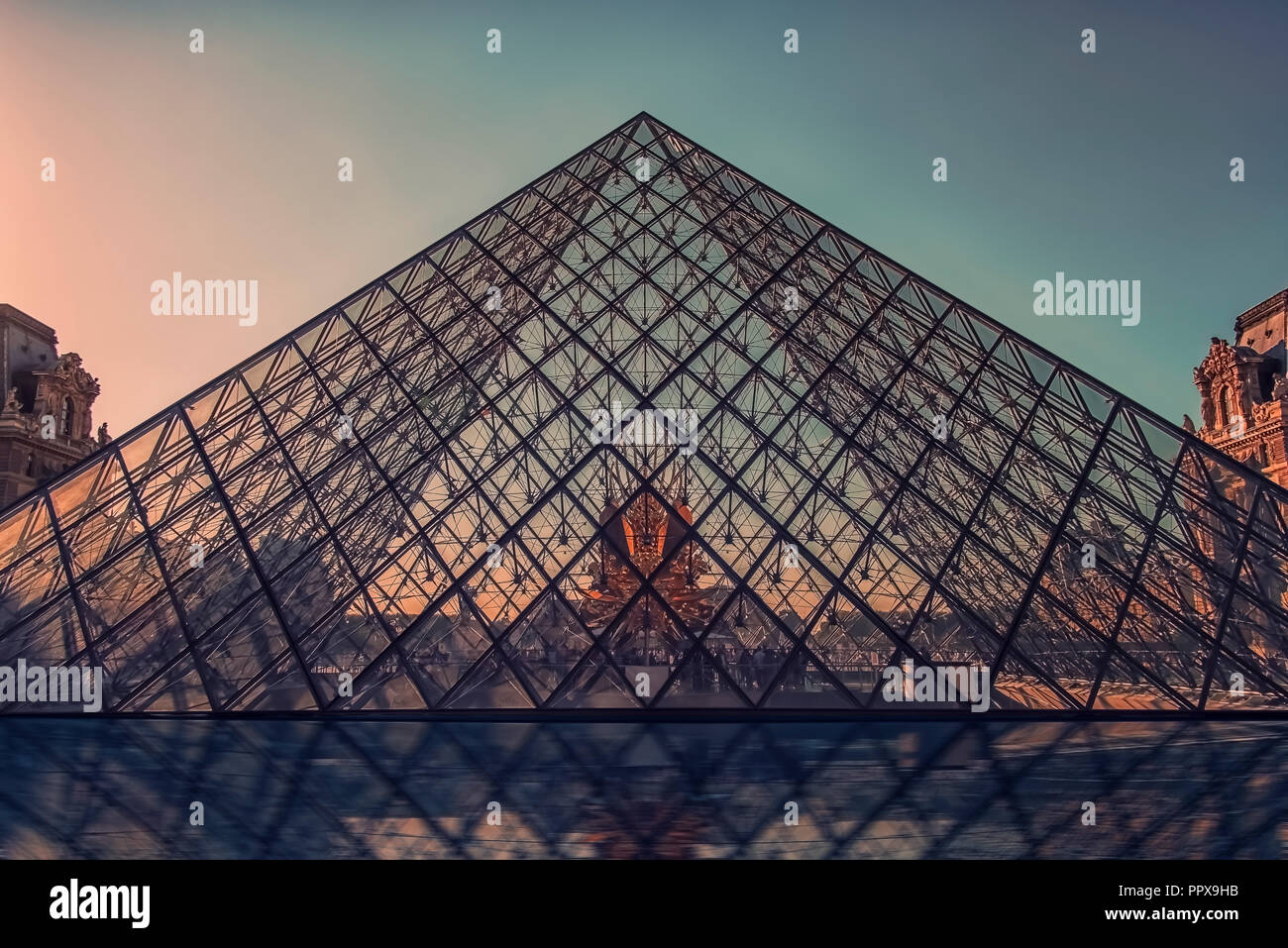 September 2018 - Paris, France- Sunset on Le Louvre museum pyramid in Paris Stock Photo