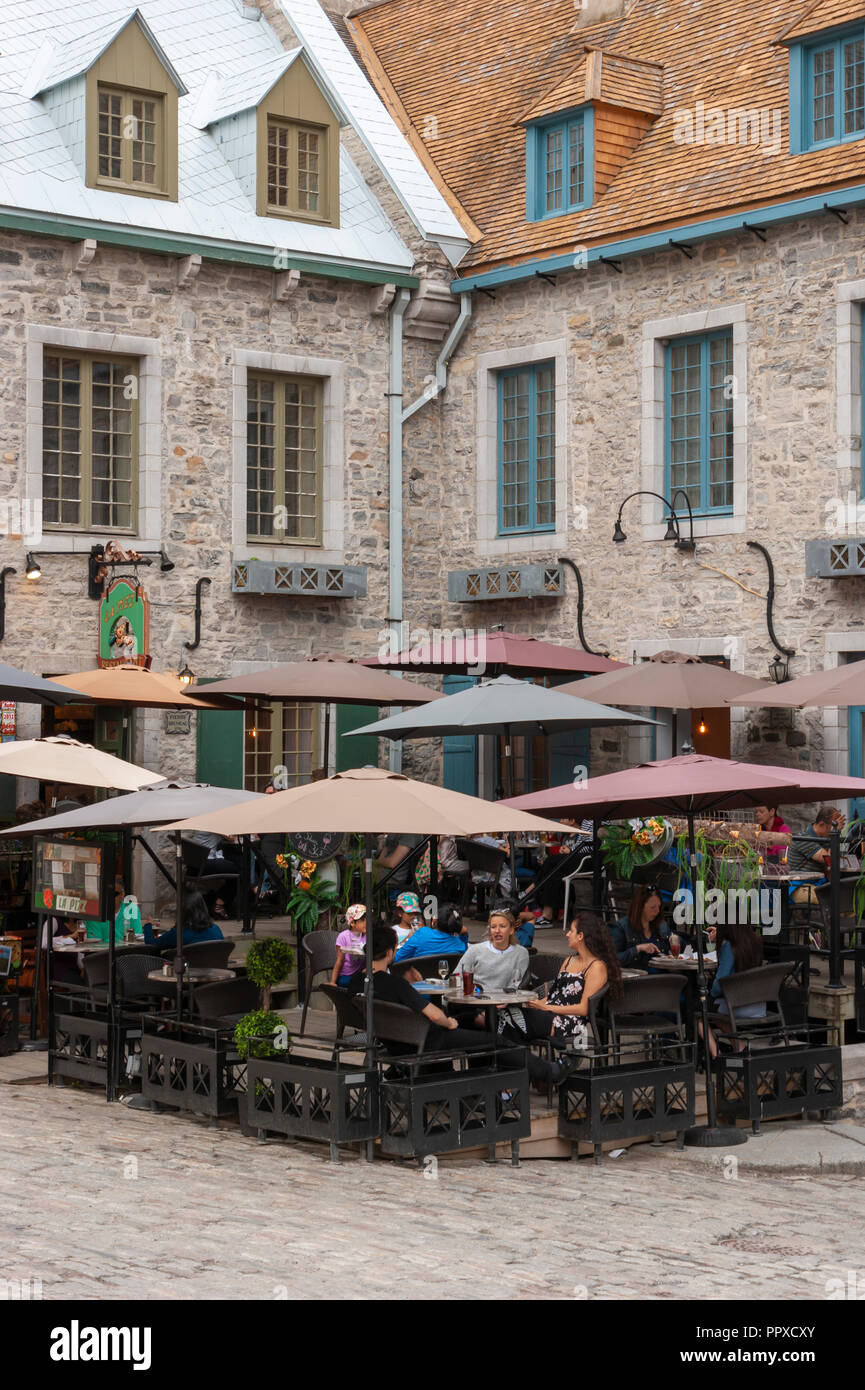 People enjoying drinks on the terrace of La Pizz Saint-Pierre, in Place Royale - the site of the first permanent French settlement in North America. Stock Photo