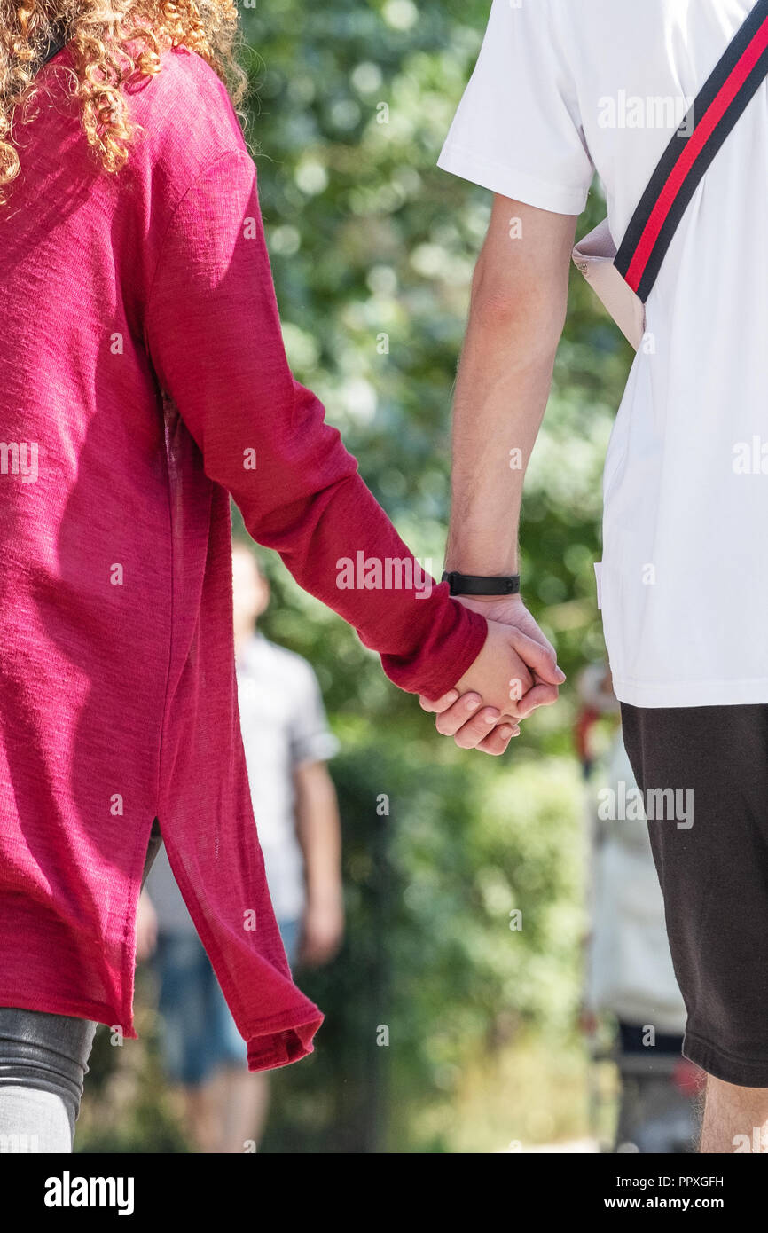 A boy and a girl are walking hand in hand. Stock Photo