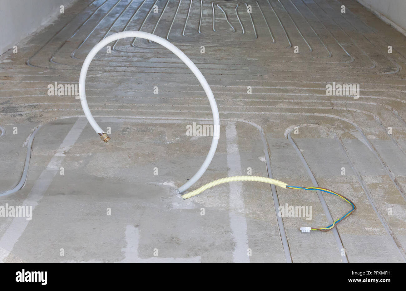 New electricity and gas pipe in a concrete floor - Building a kitchen island Stock Photo