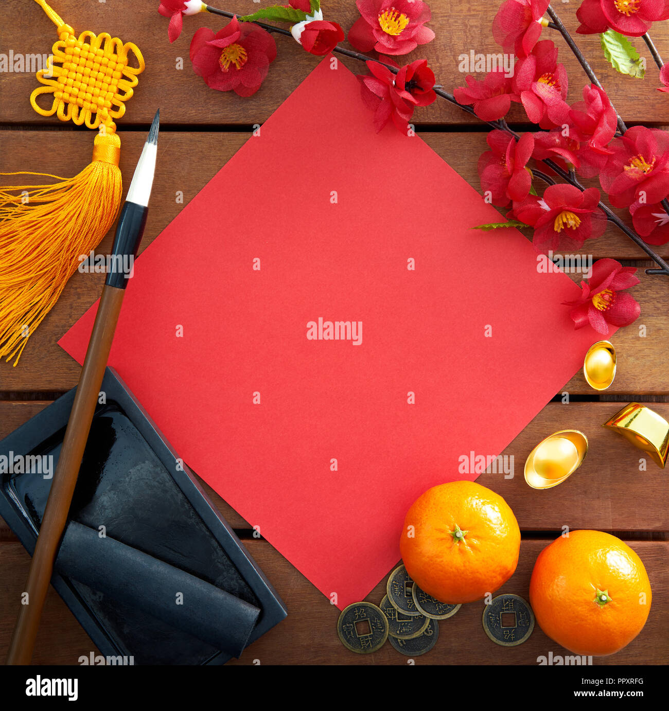Top view of Chinese new year decorations with a blank red paper as copy space Stock Photo