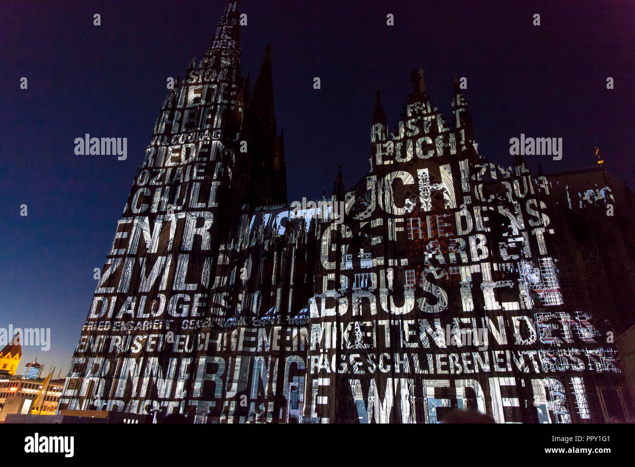Cologne, Germany, September 27th. 2018. evening illumination of the cathedral during the cathedral pilgrimage 2018. This is a reminder of the end of World War I 100 years ago. Moving light projections by the artists Detlef Hartung and Georg Trenz on the south facade tell of the futility of war. Stock Photo