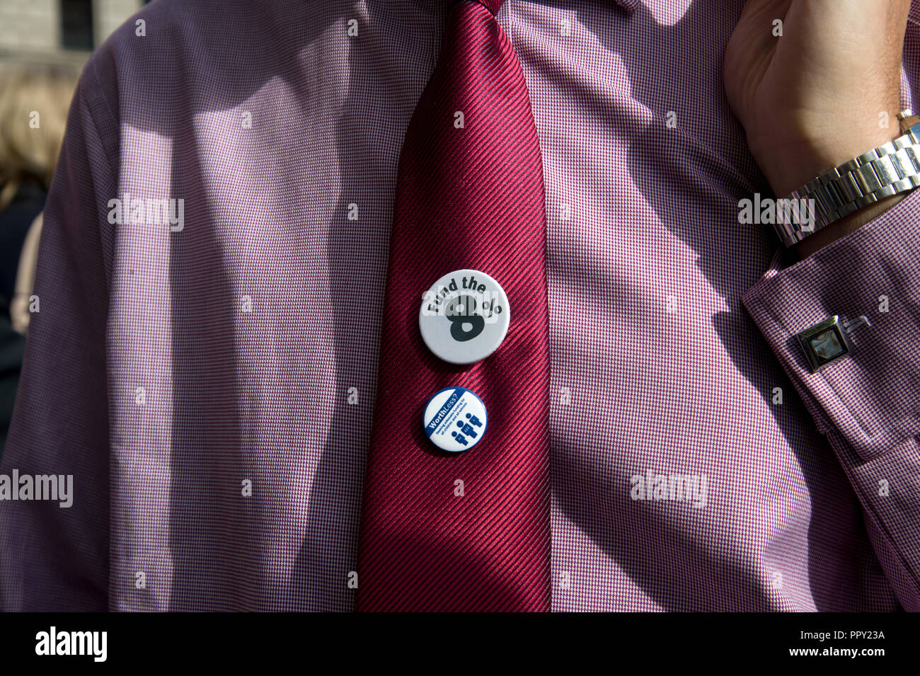 Westminster. London, UK. September 28th 2018. Headteachers from all over the country demonstrated in Parliament Square over cuts to state school funding and walked to Downing Street where they handed in a letter to the Chancellor of the Exchequer, Philip Hammond. The badge refers to the 8% cut. Credit: Jenny Matthews/Alamy Live News Stock Photo