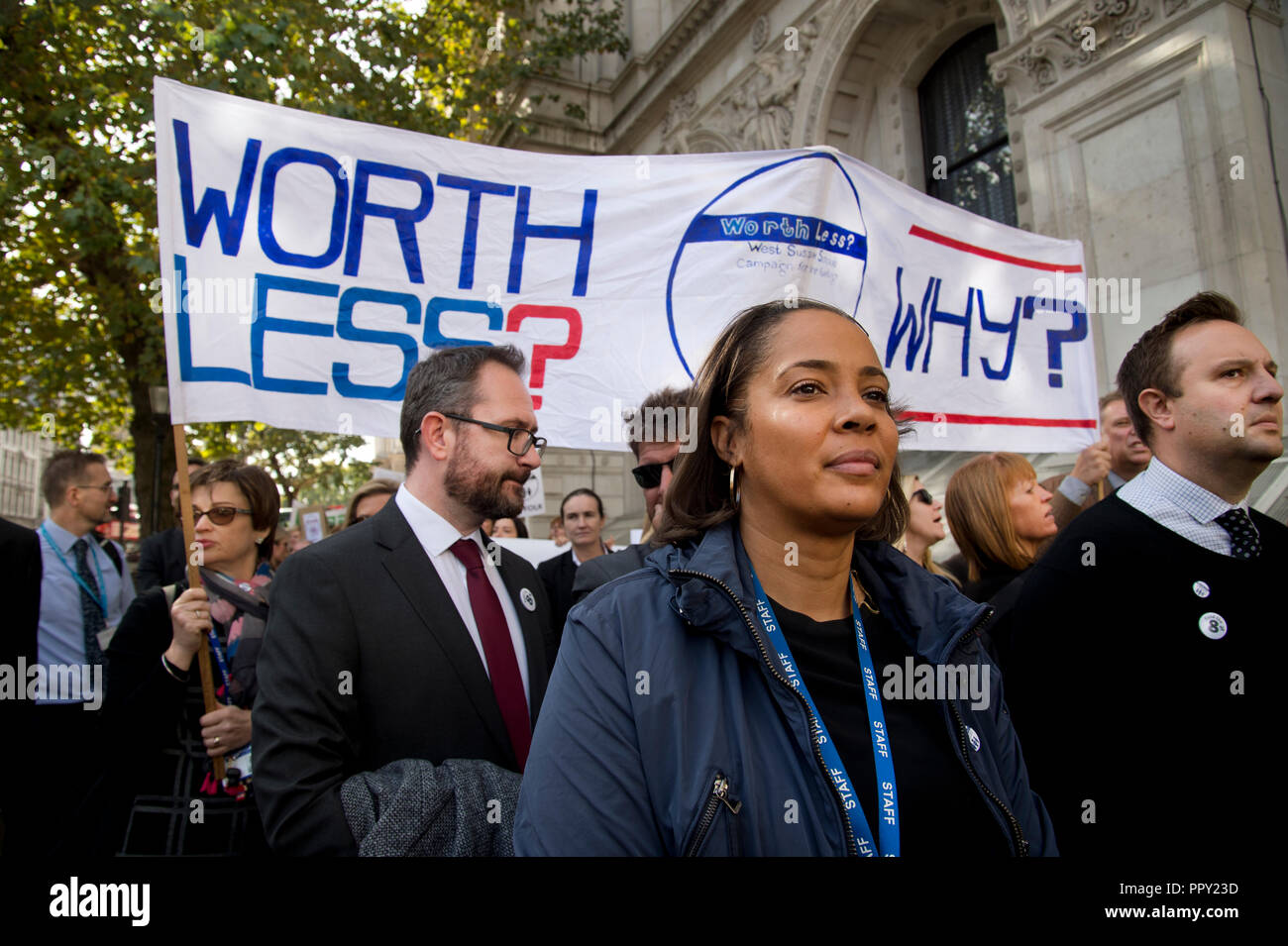 Westminster. London, UK. September 28th 2018. Headteachers from all over the country demonstrated in Parliament Square over cuts to state school funding and walked to Downing Street where they handed in a letter to the Chancellor of the Exchequer, Philip Hammond. Headteachers walk behind a banner saying 'Worth-less . Why?. Credit: Jenny Matthews/Alamy Live News Stock Photo