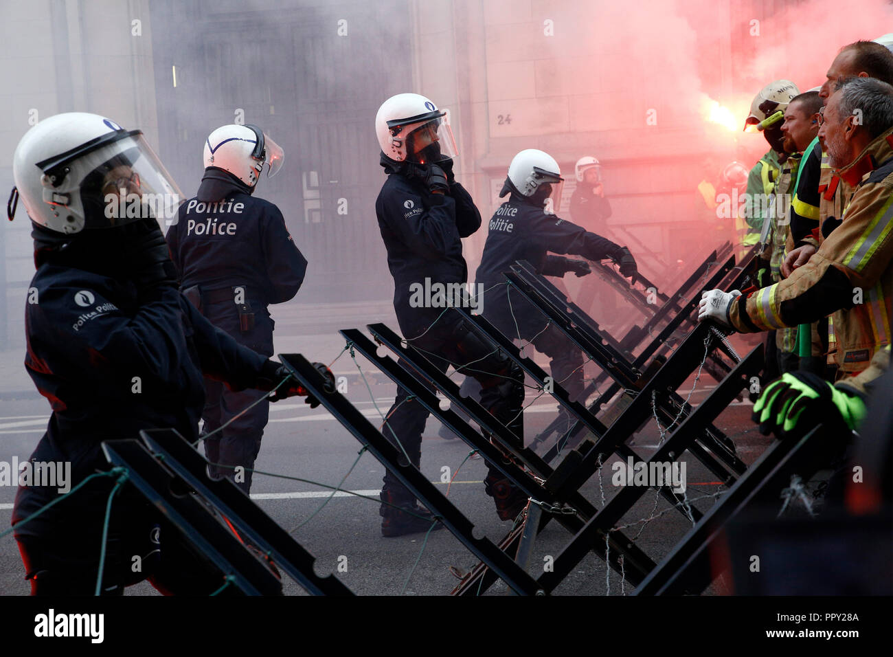 Brussels, Belgium. 28th Sep. 2018. Firefighters and workers from public sector scuffle with riot police during a protest against planned pension reforms. Alexandros Michailidis/Alamy Live News Stock Photo