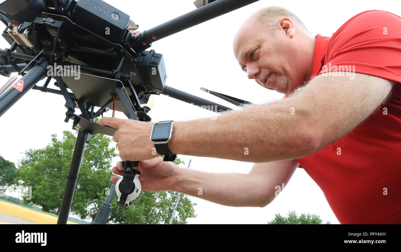 Iowa, USA. 31st Aug, 2018. WQAD's Doug Froehlich attaches a camera to 'NED'' (an acronym for News Eight Drone) which is the largest and most costly unit in the WQAD News Channel 8 drone fleet. Credit: Quad-City Times/ZUMA Wire/Alamy Live News Stock Photo
