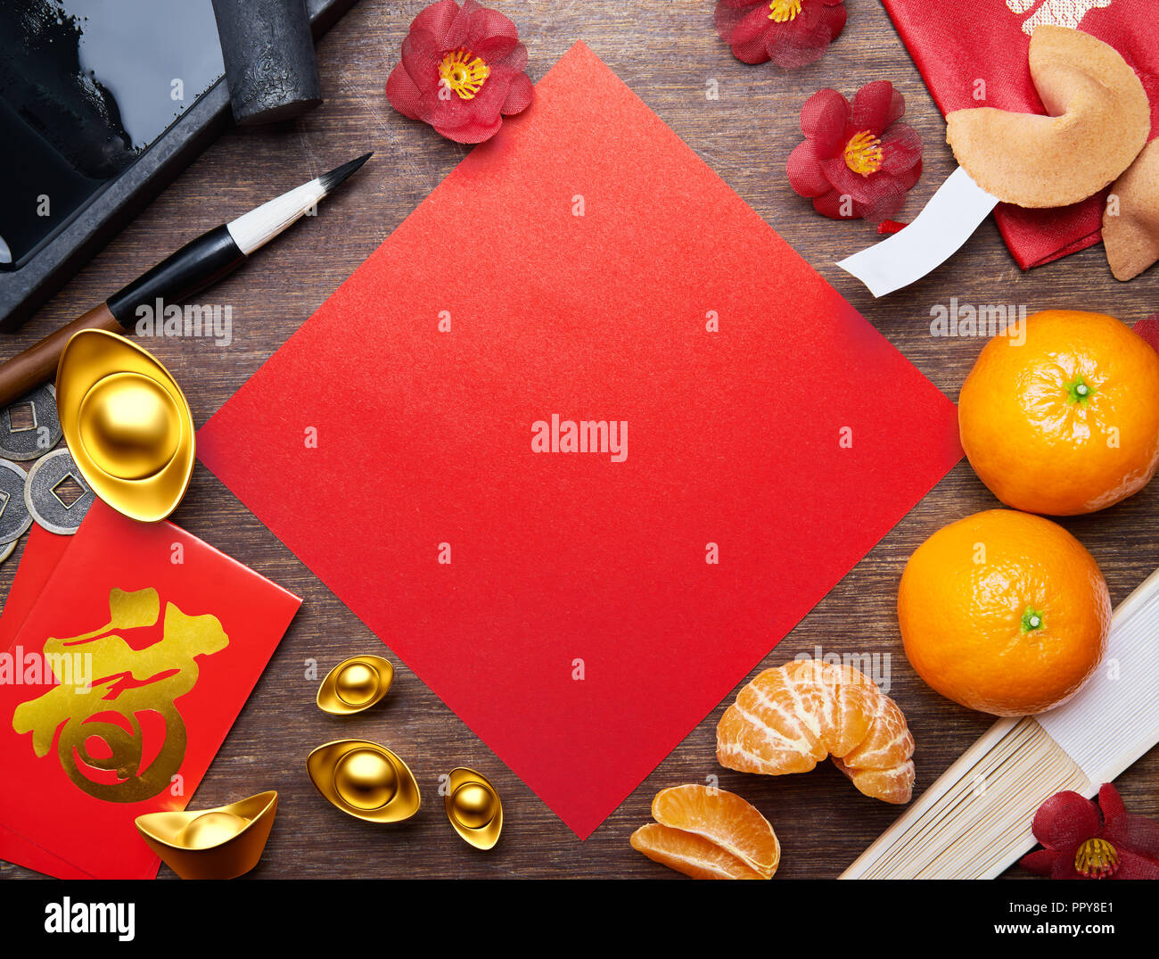 Top view of Chinese new year decorations with blank red paper as copy space, Chinese calligraphy on red packet 'FU' (Foreign text means Prosperity) Stock Photo