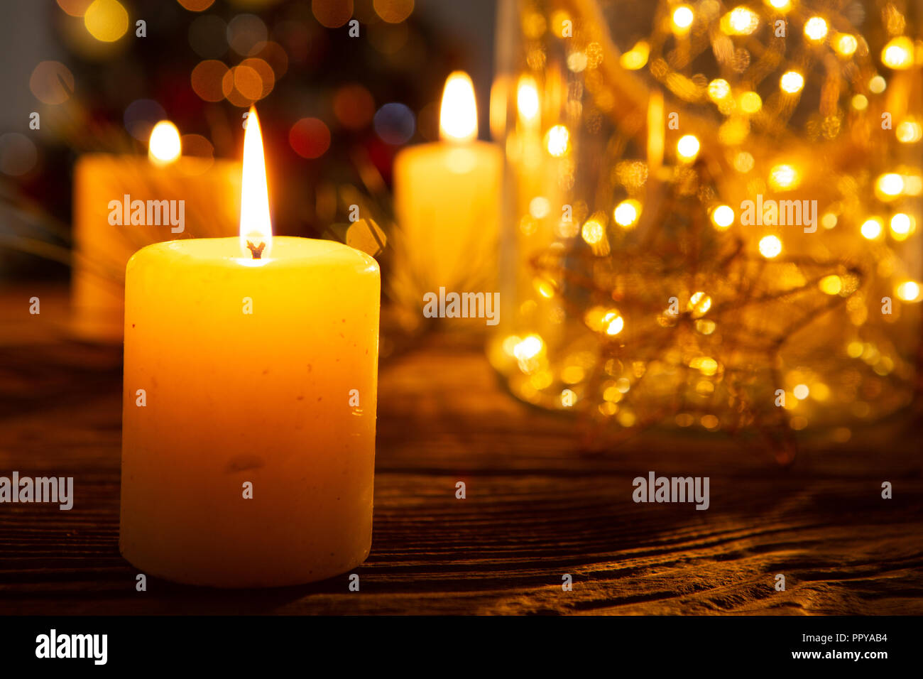 Christmas candles on wooden table Stock Photo