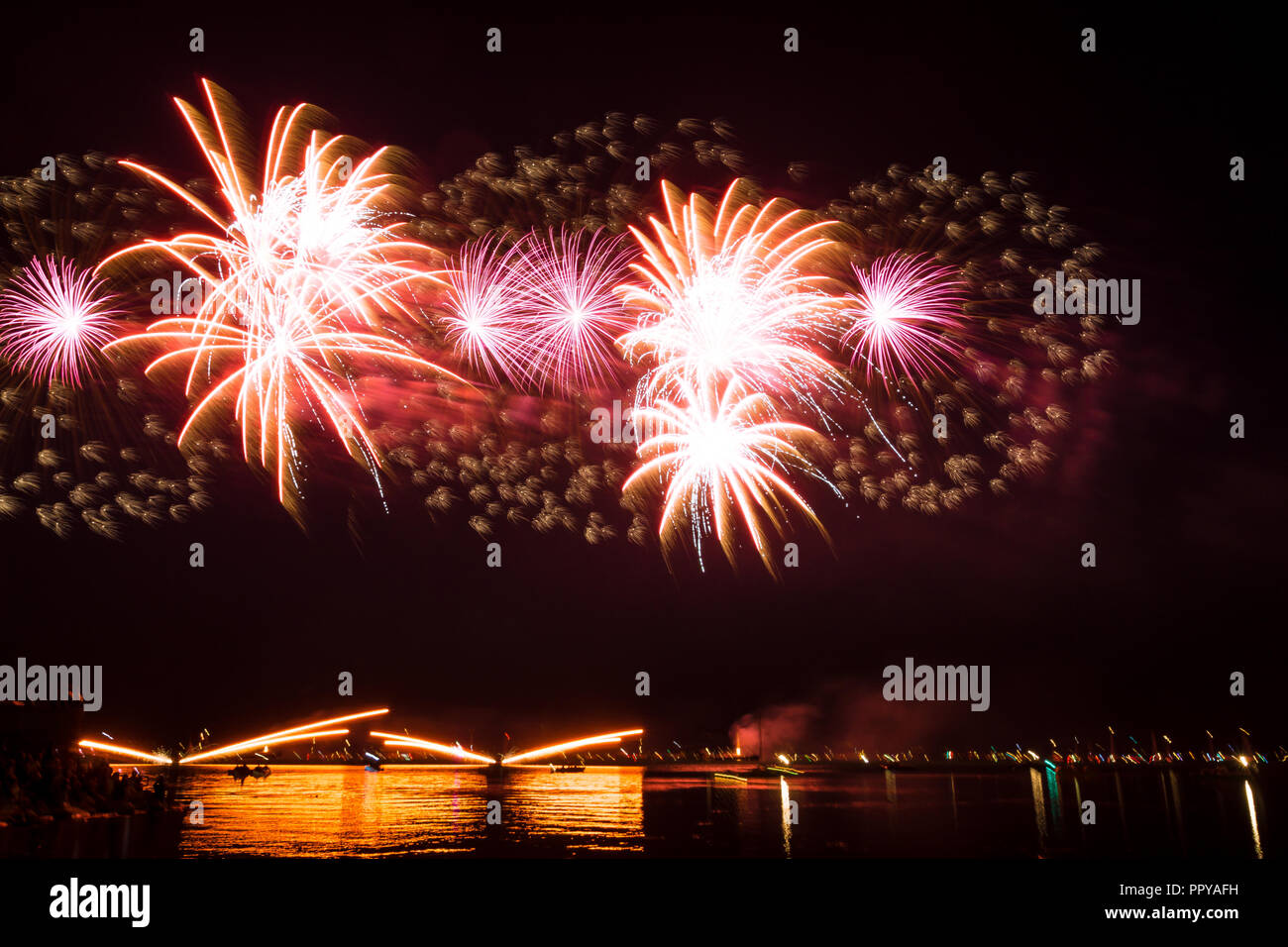Giant purple firework celebration at a lake Stock Photo