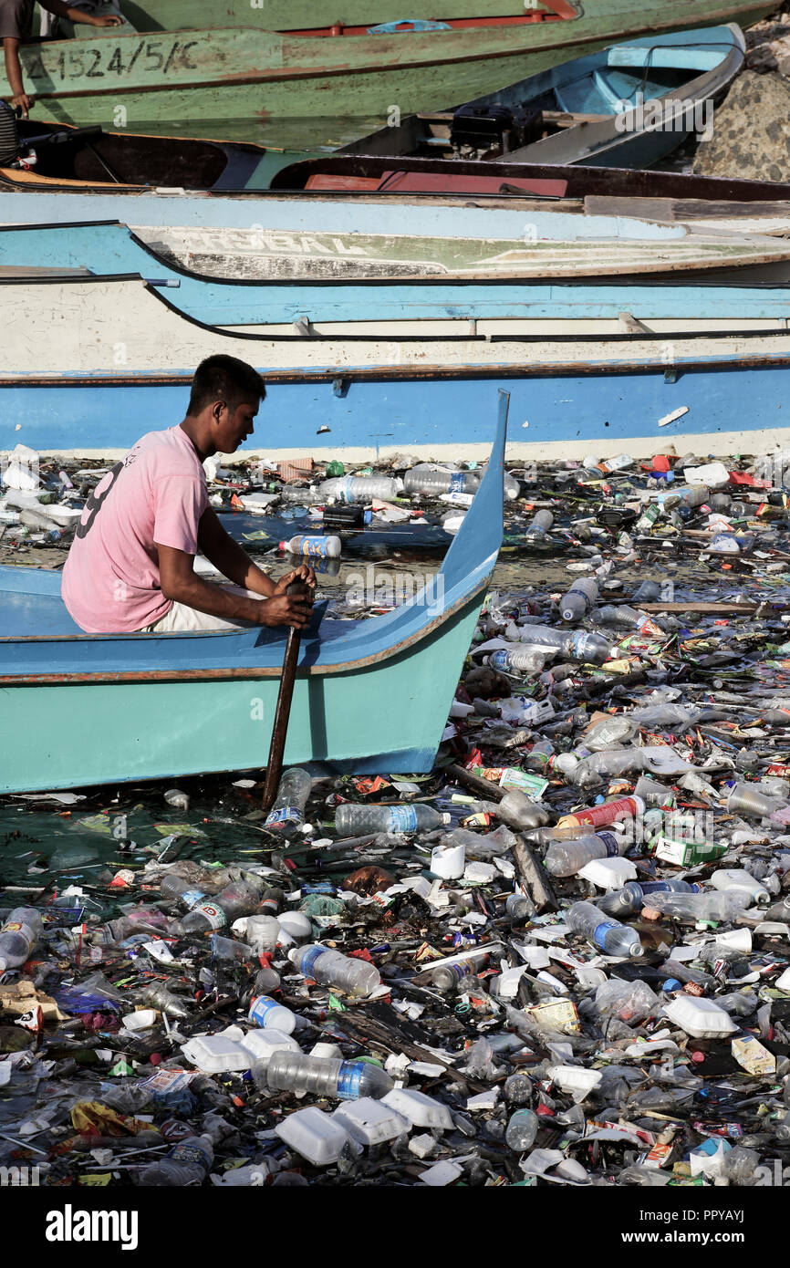Man In Water Taxi Boat Paddles Through Ocean Full Of Plastic Bags Plastic Bottles Polystyrene And Other Trash In Semporna Borneo Malaysia Stock Photo Alamy