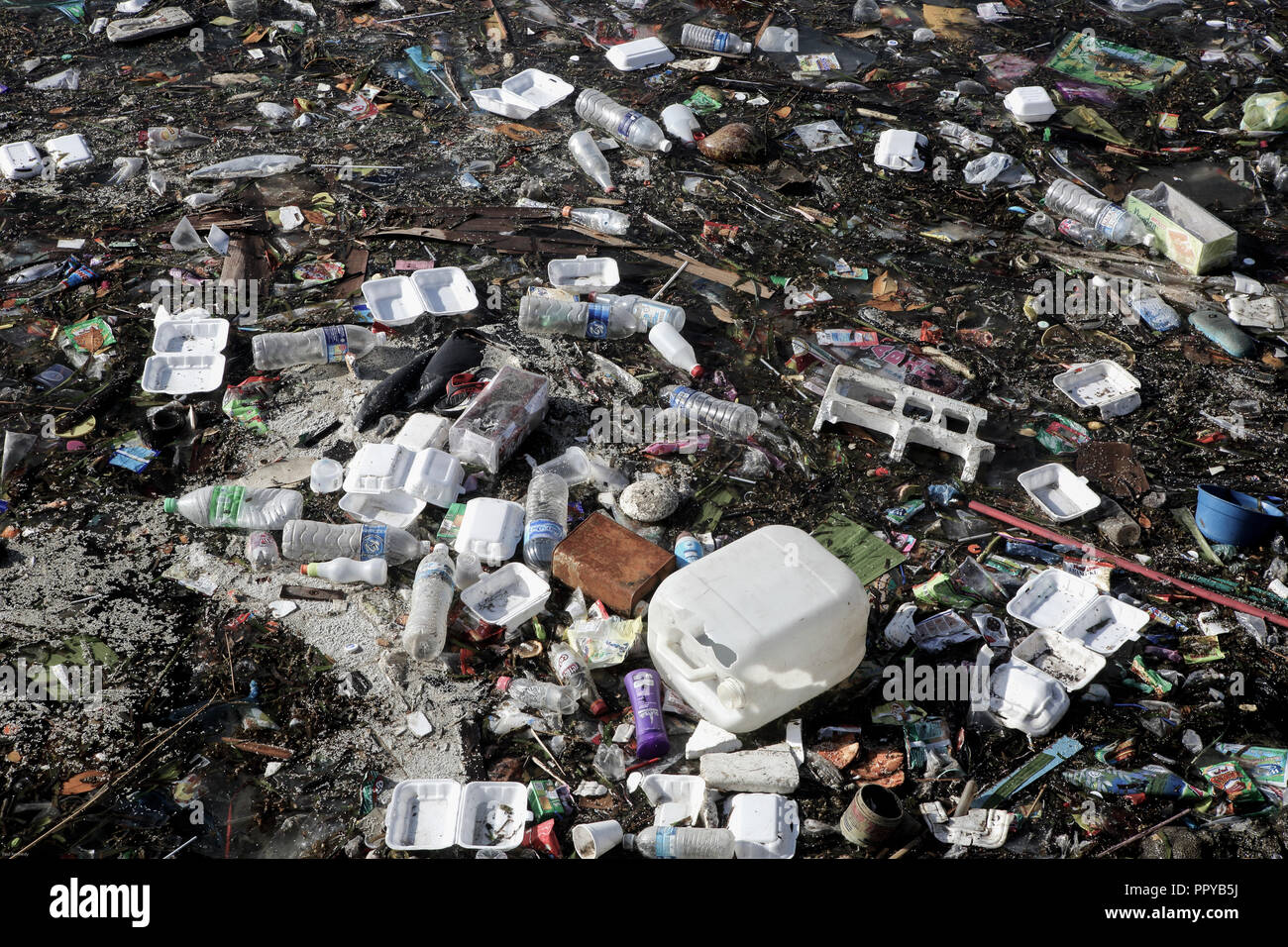 Plastic bottles, plastic bags, polystyrene and other trash floating on