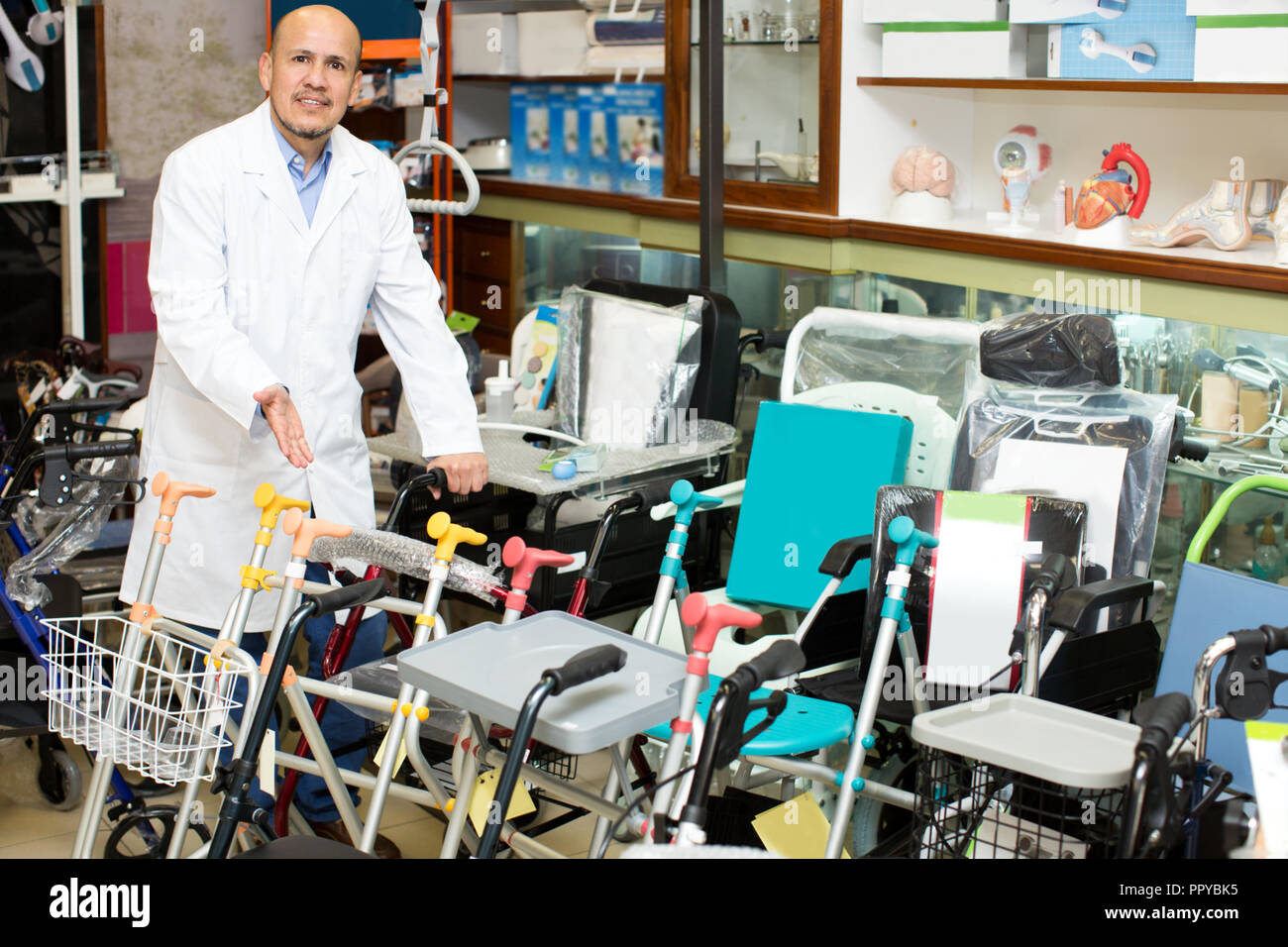 Positive professional consultant offering orthopaedic goods in store