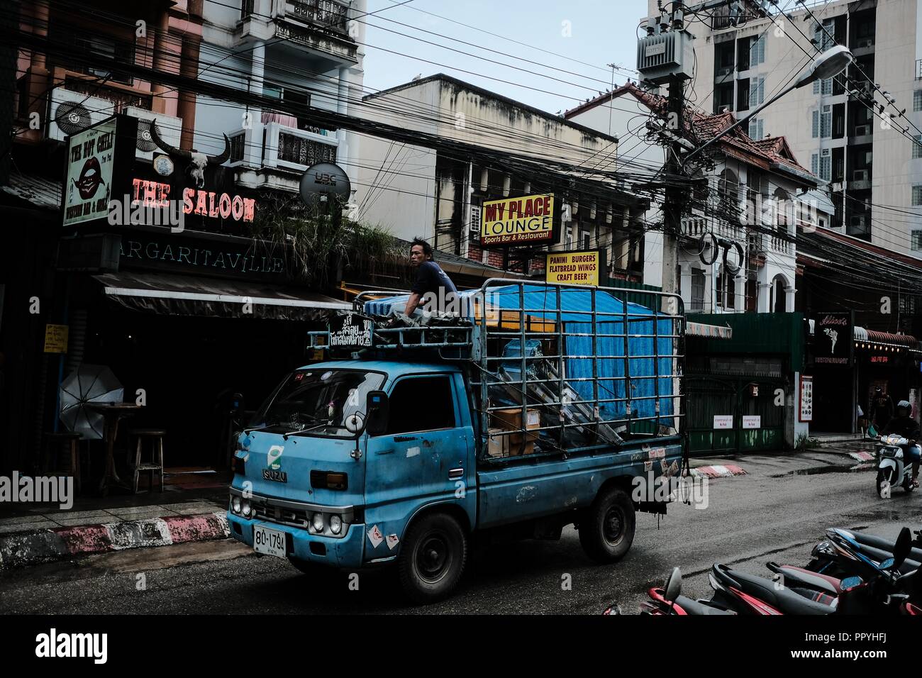 A Passing Truck on a Chiang Mai Street in the Rain, Thailand Stock Photo