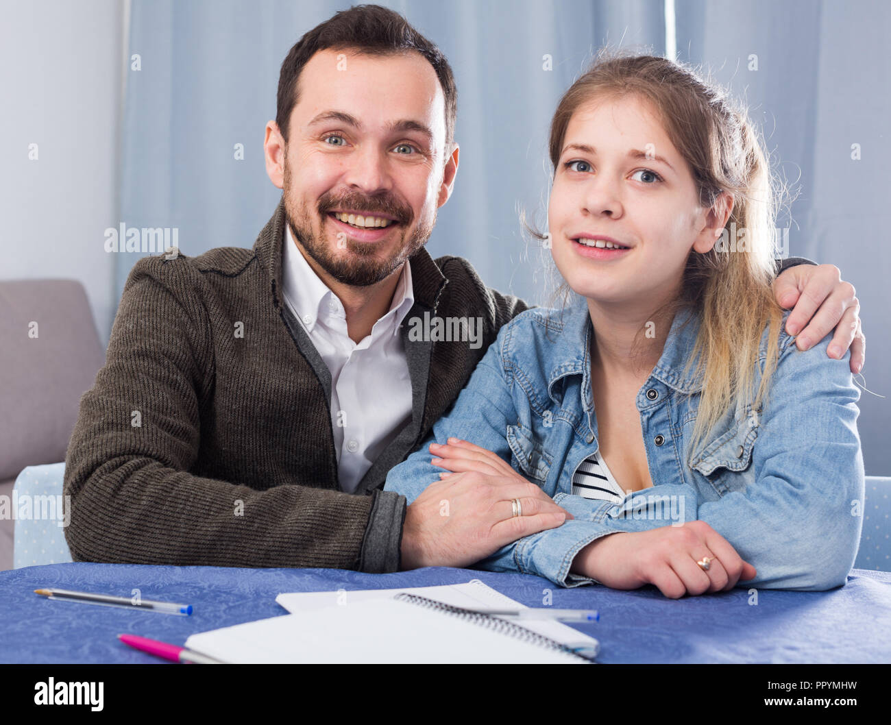 Father helping his child to do homework at home Stock Photo - Alamy