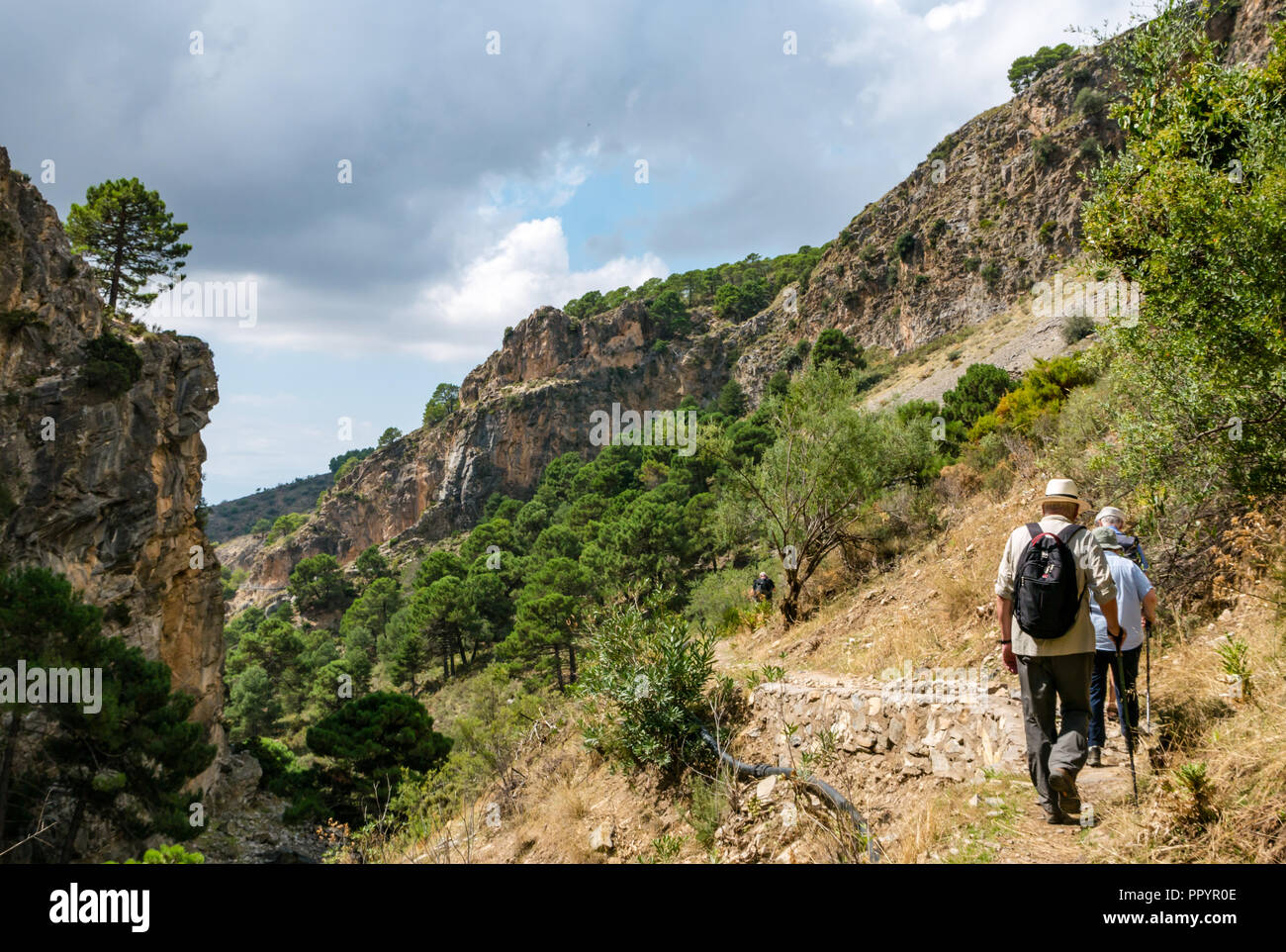 People walking on mountain path, Sierras de Tejeda Natural Park, Axarquia, Andalusia, Spain Stock Photo