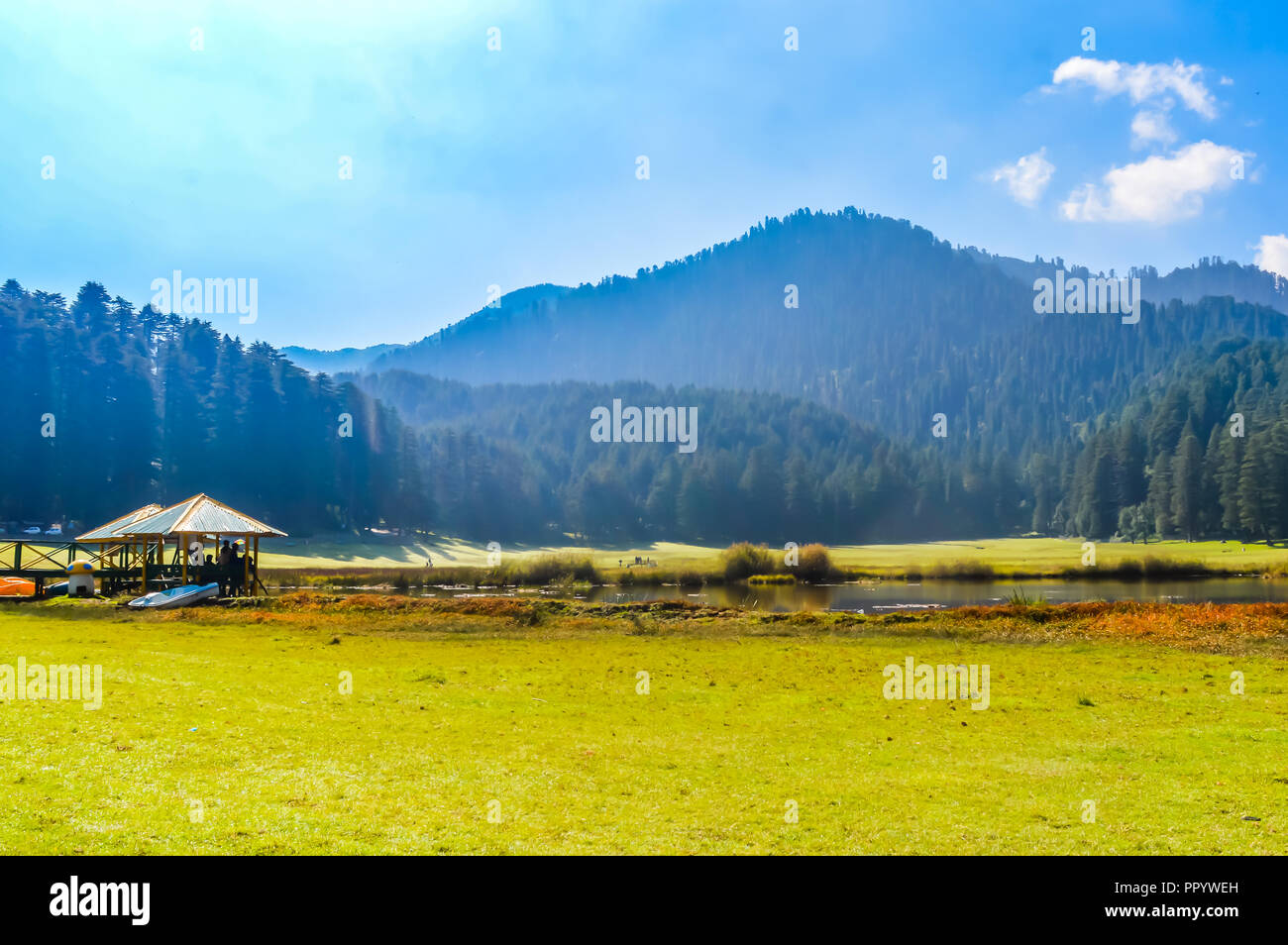 A beautiful golf course on a hill station with road blue sky trees clouds.  Captured in sunny day hill station India taken landscape style useful for b  Stock Photo - Alamy