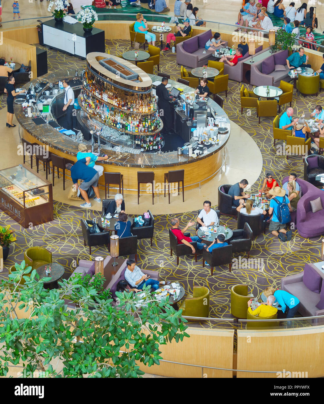 SINGAPORE - FEBRUARY 18, 2017 : People at thea restaurant in a hotel hall of Marina Bay Sands, one of the most luxurious hotels in the world. Stock Photo