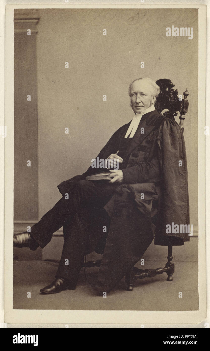 elderly man seated with a book in his lap, finger holding its place; Thomas Rodger, Scottish, 1832 - 1883, 1864 - 1865; Albumen Stock Photo