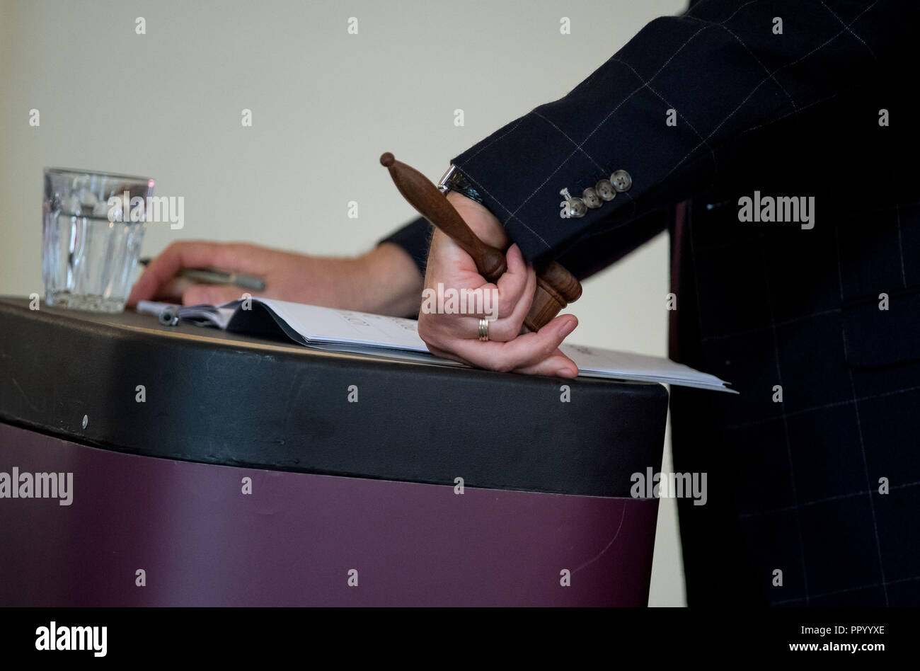 Gavel which is a small ceremonial mallet commonly made of hardwood, typically fashioned with a handle. Here it is being used at a housing auction. Stock Photo