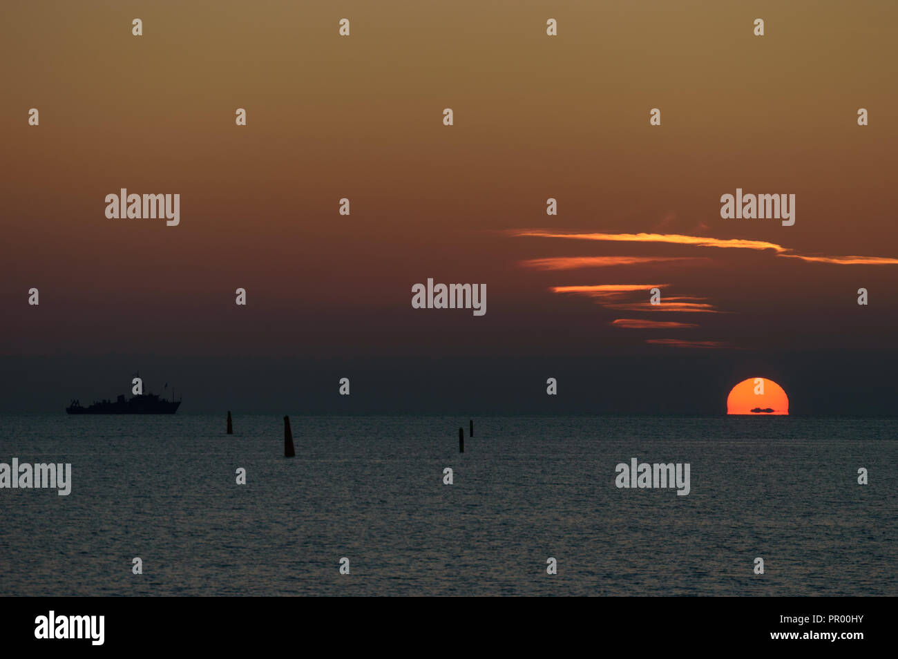 Spectacular sunset over the sea with vibrant colors Stock Photo - Alamy