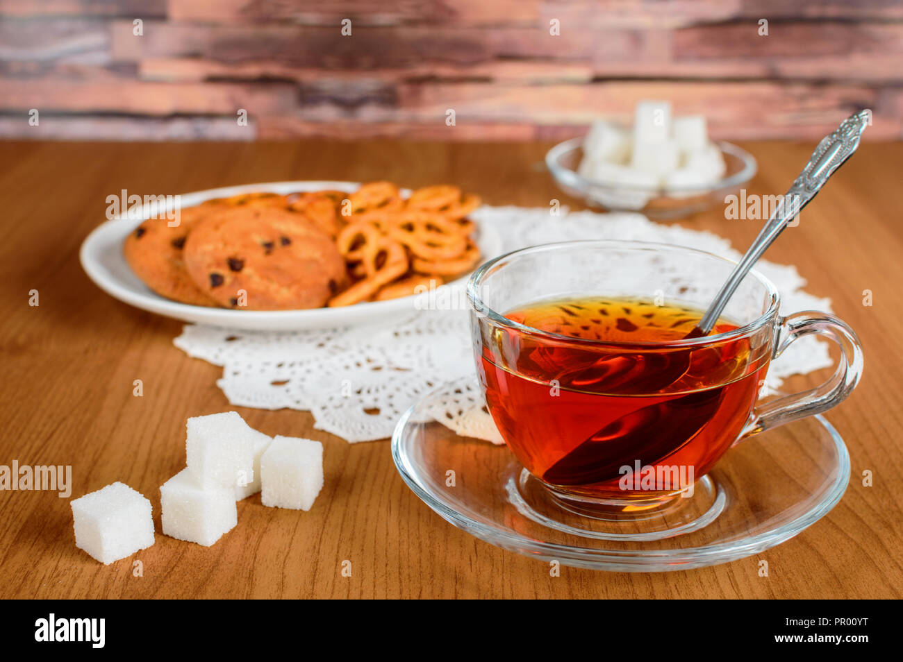 rich tea in a glass Cup. cookies and refined sugar Stock Photo