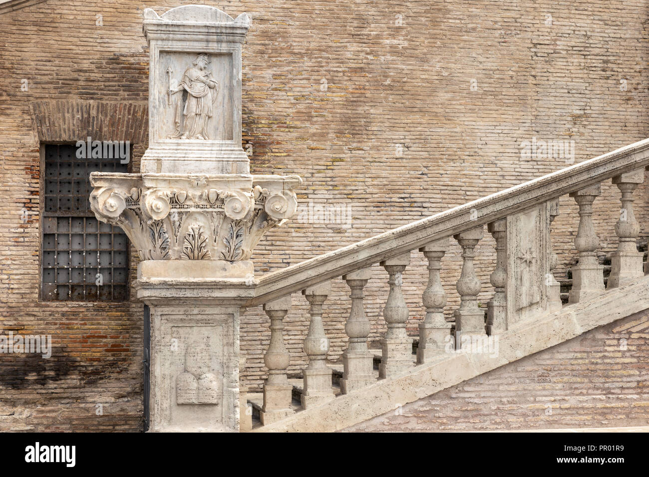 Ancient staircase of a Roman church. Detail of the bas-relief on the  chapiter Stock Photo