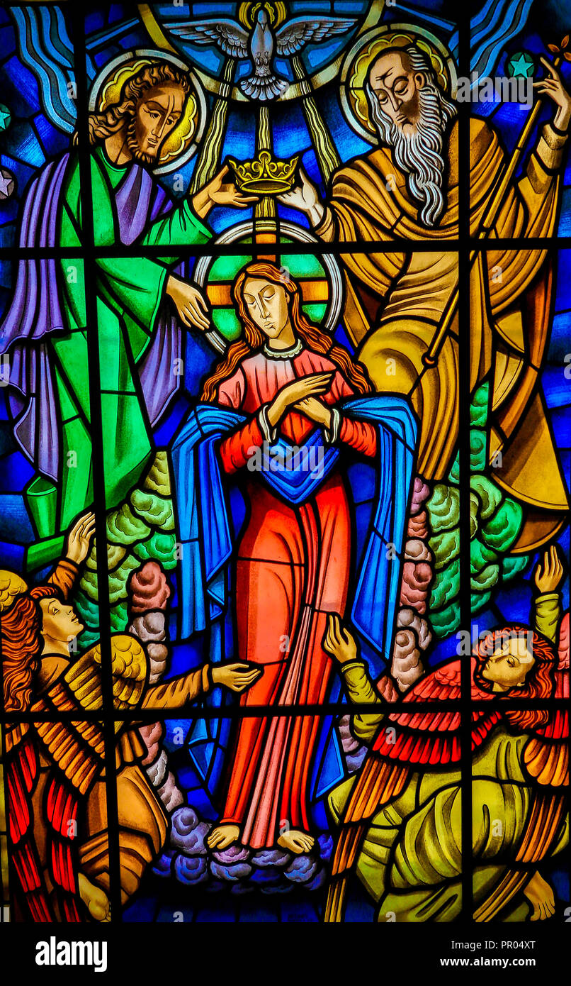 Stained glass window depicting Mother Mary and the Holy Trinity in Ponte de Lima, a town in Portugal. Stock Photo