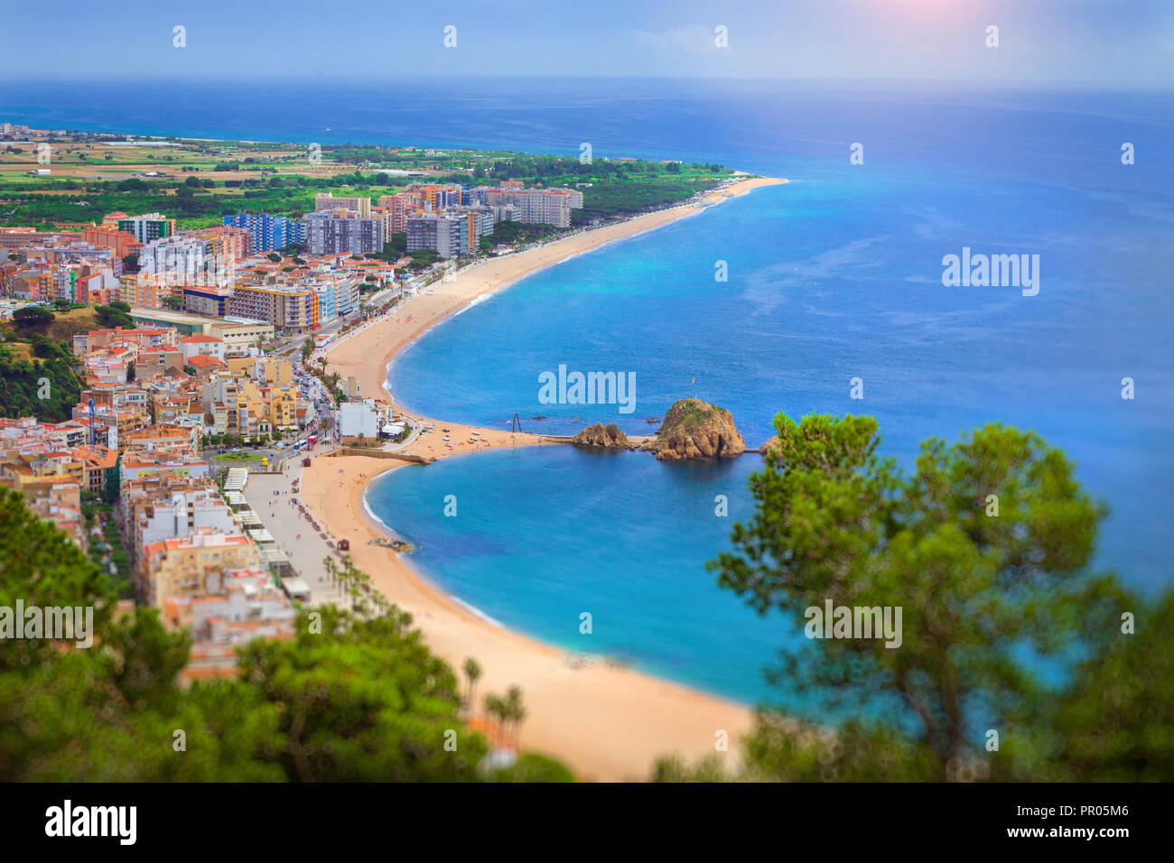 Spanish beach resort Blanes in summertime. Coast, rock Sa Palomera and