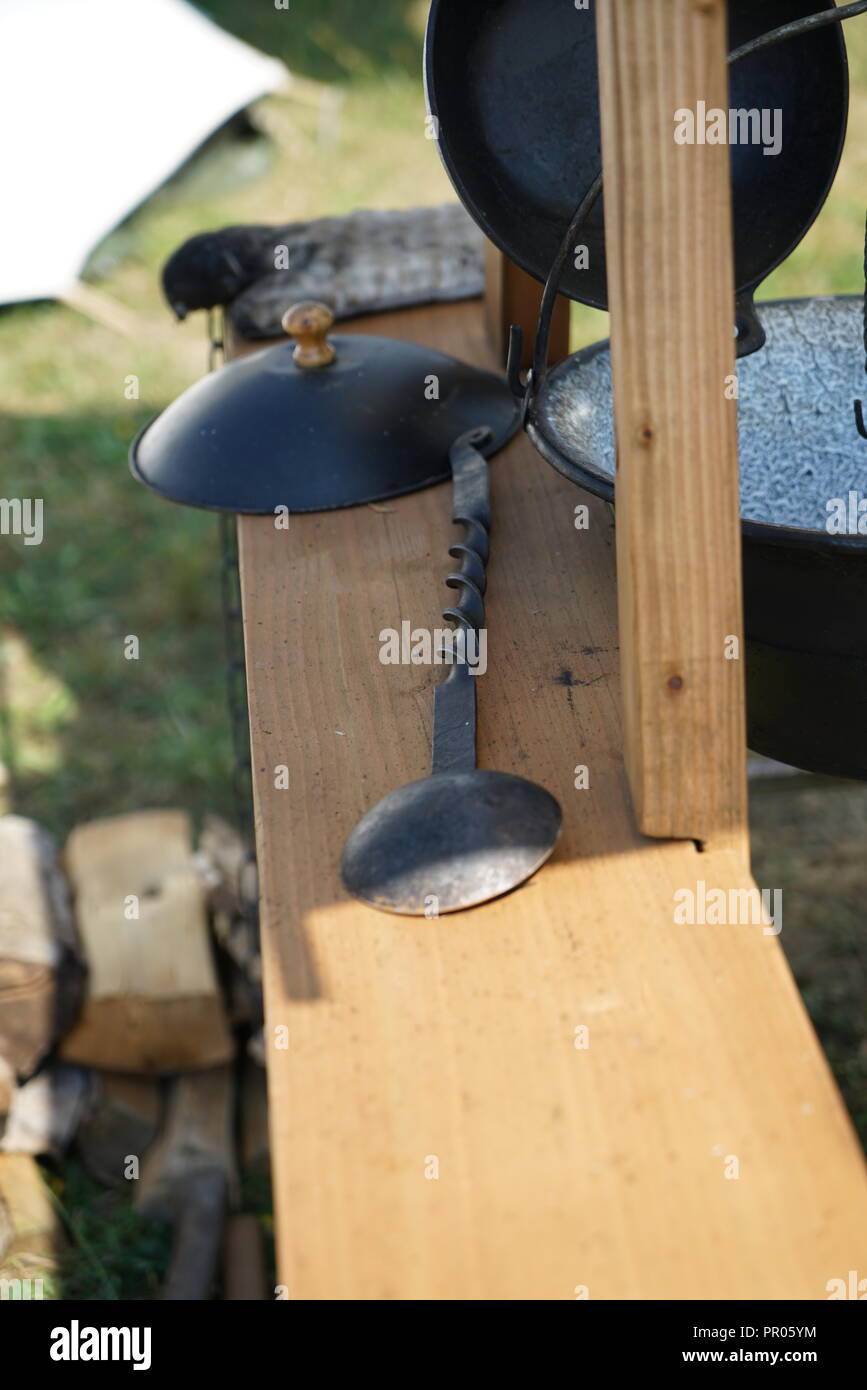 Primitive cooking on open flame with old pots and pans in Germany on a
