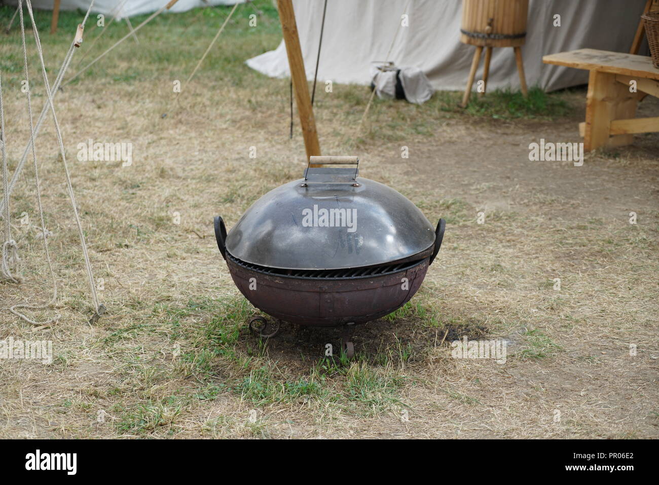 Primitive cooking on open flame with old pots and pans in Germany on a