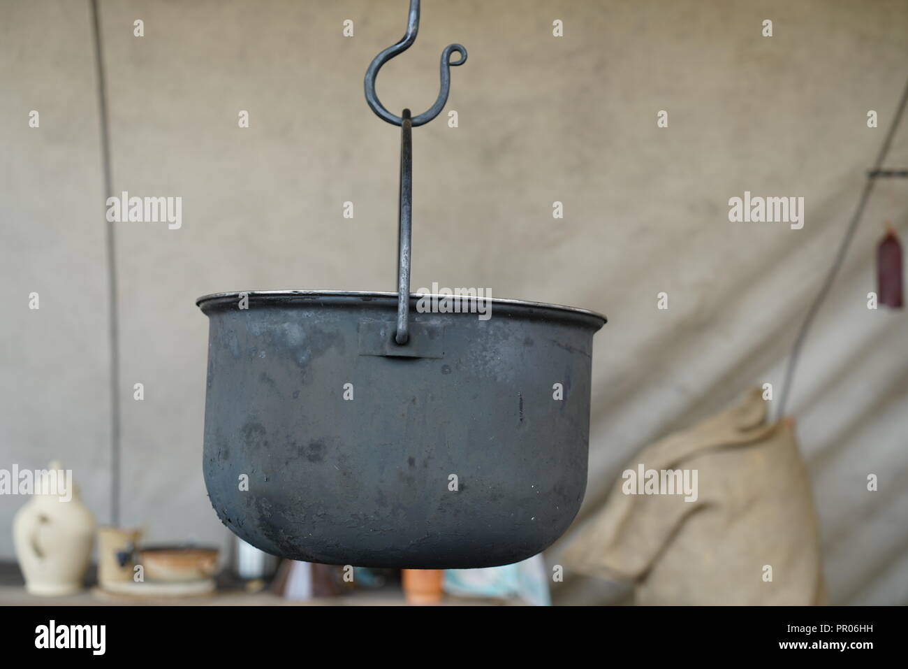 Primitive cooking on open flame with old pots and pans in Germany on a