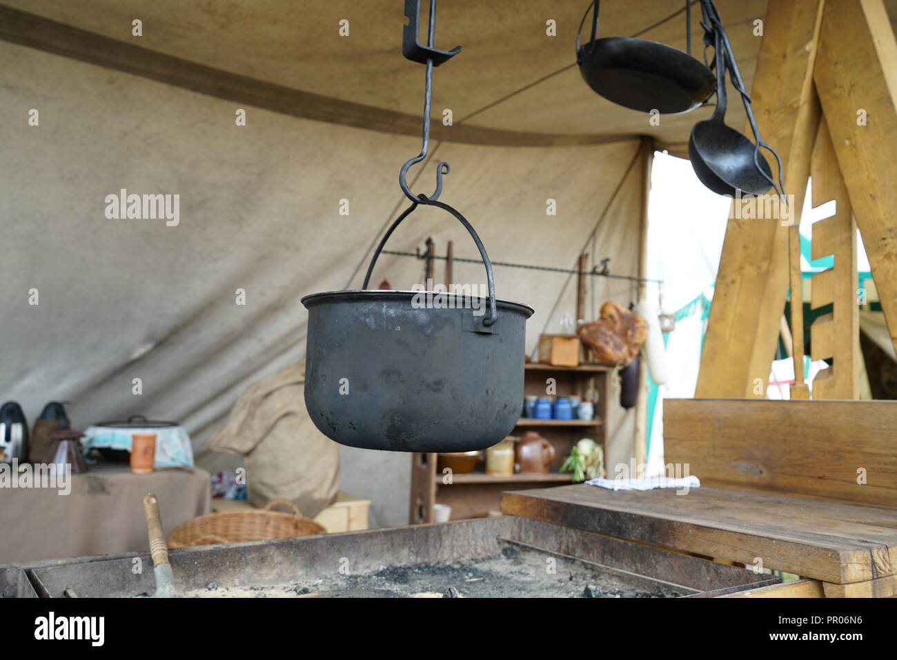 Primitive cooking on open flame with old pots and pans in Germany on a