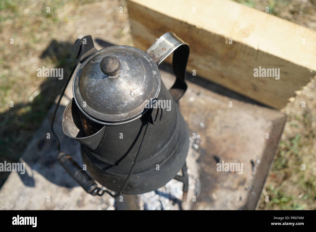 Primitive cooking on open flame with old pots and pans in Germany on a